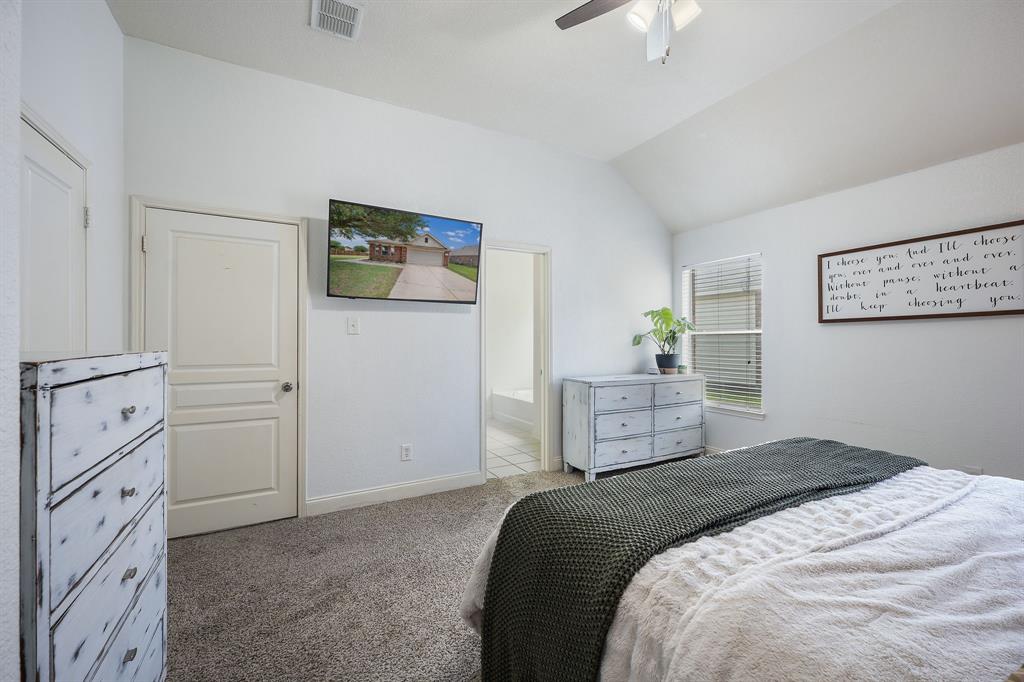 14152 Rodeo Daze Drive Fort Worth, TX 76052 - Photo 15 of 20 Vaulted ceiling bedroom featuring carpeting, a ceiling fan with light fixture, a window with blinds, and white interior doors