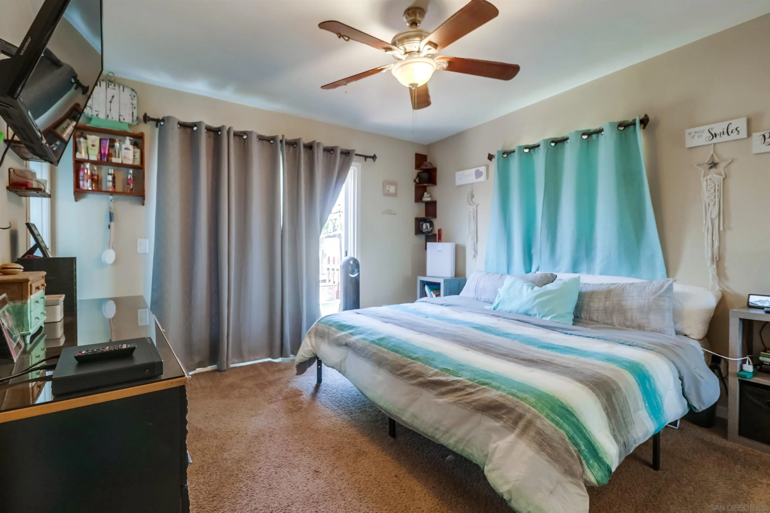 9833 St George Street Spring Valley, CA 91977 - Photo 11 of 19 a bedroom with a large bed and a flat tv screen