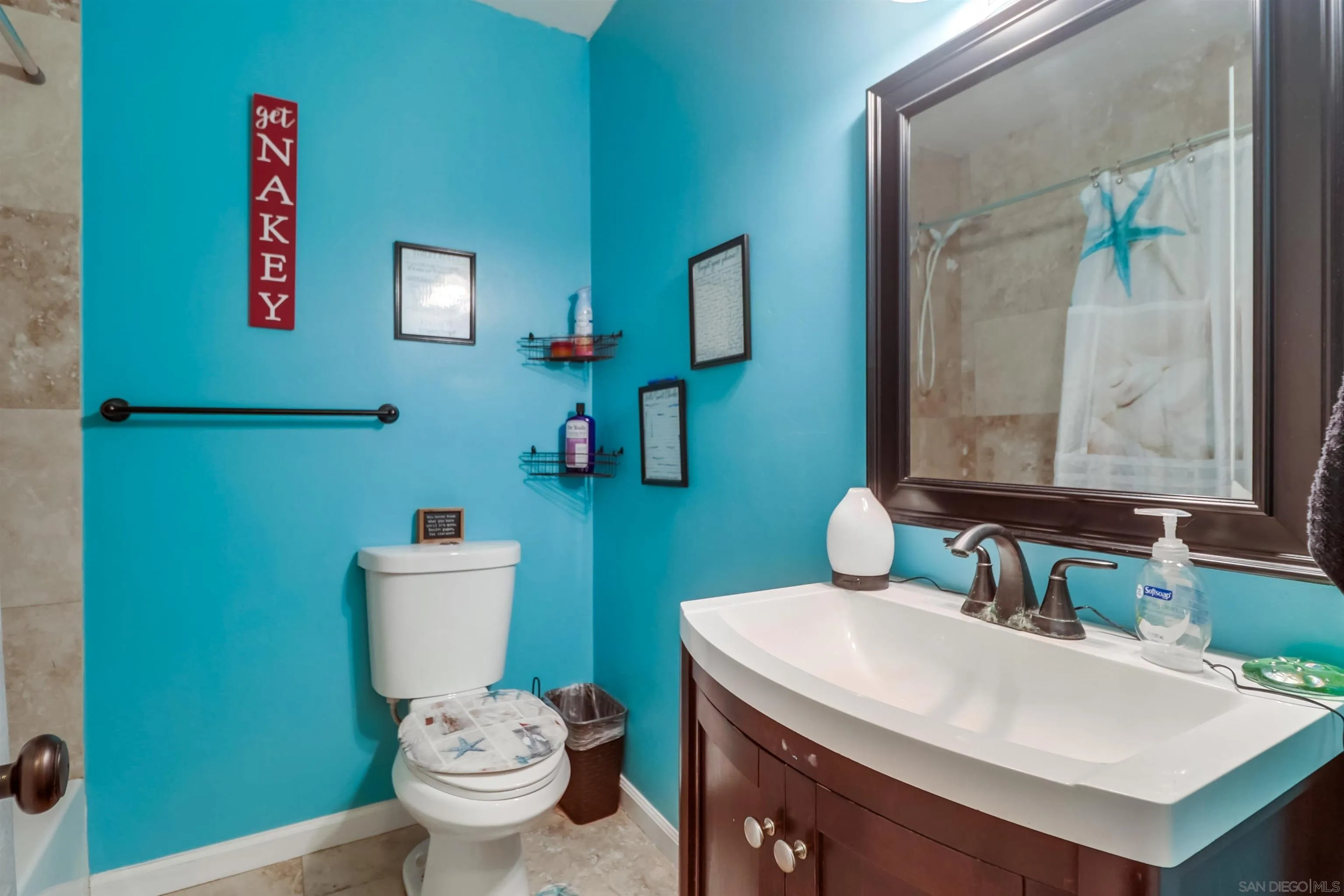 9833 St George Street Spring Valley, CA 91977 - Photo 13 of 19 a bathroom with a toilet sink and mirror