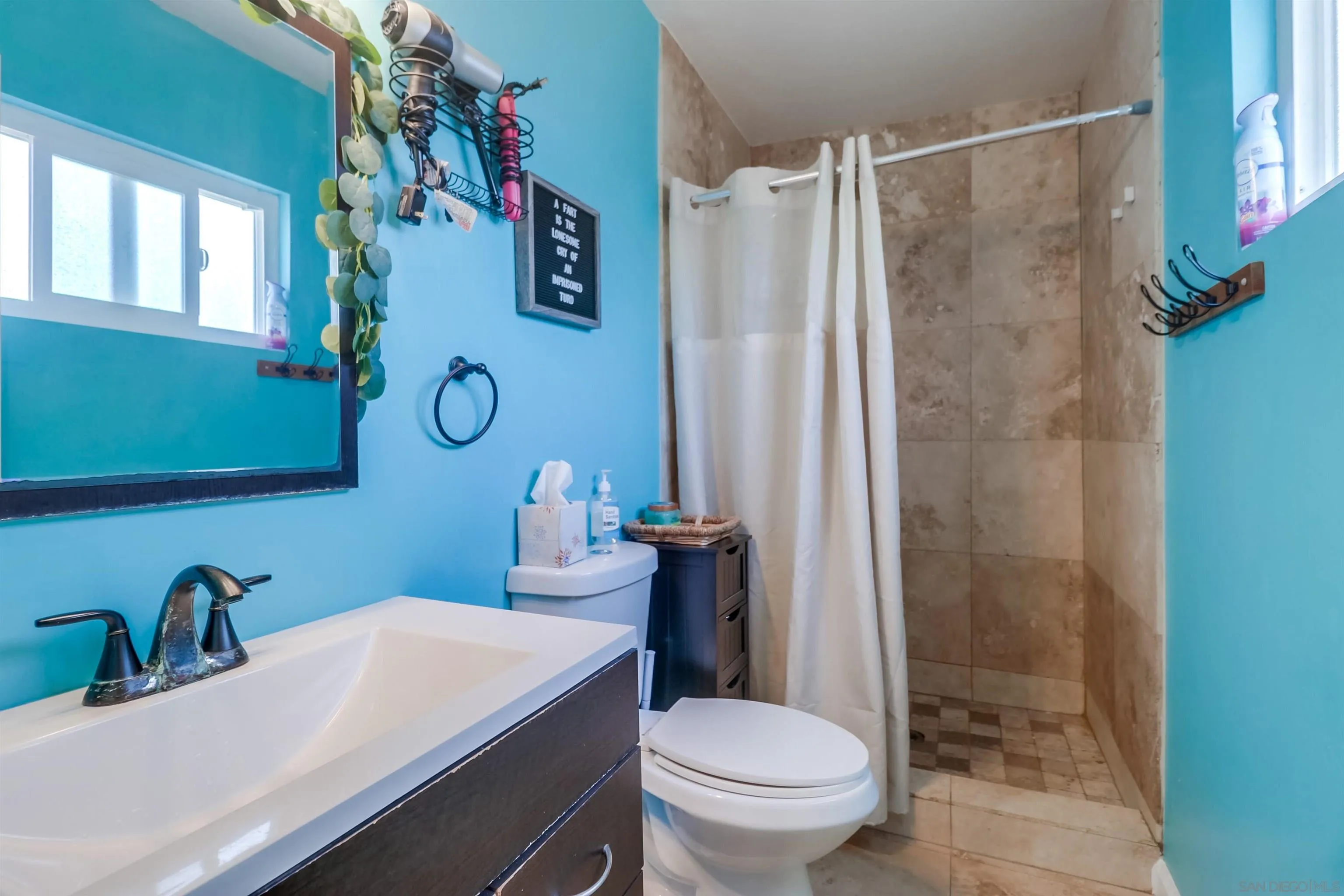 9833 St George Street Spring Valley, CA 91977 - Photo 18 of 19 a bathroom with a sink toilet and shower