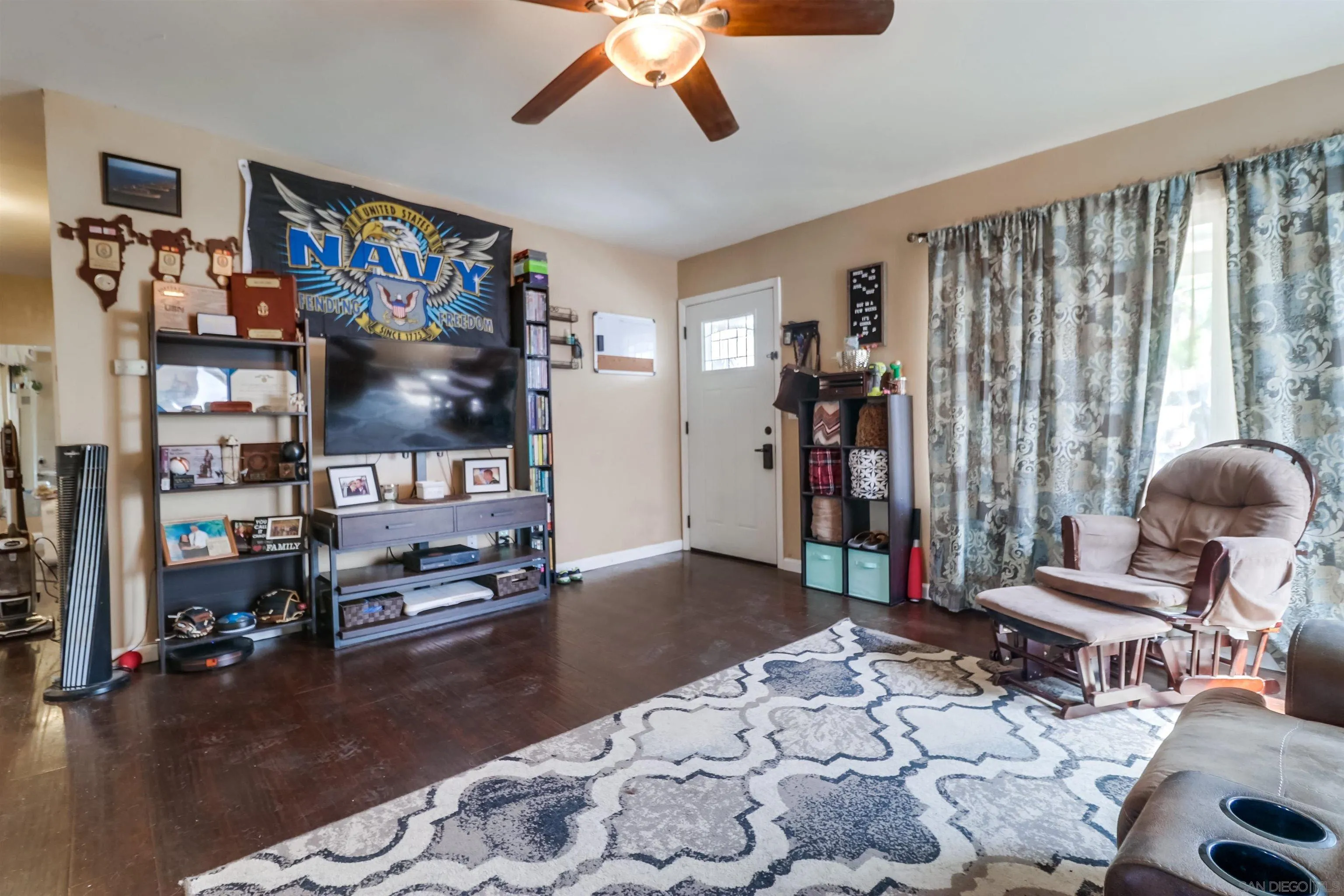 9833 St George Street Spring Valley, CA 91977 - Photo 4 of 19 a living room with furniture and a flat screen tv