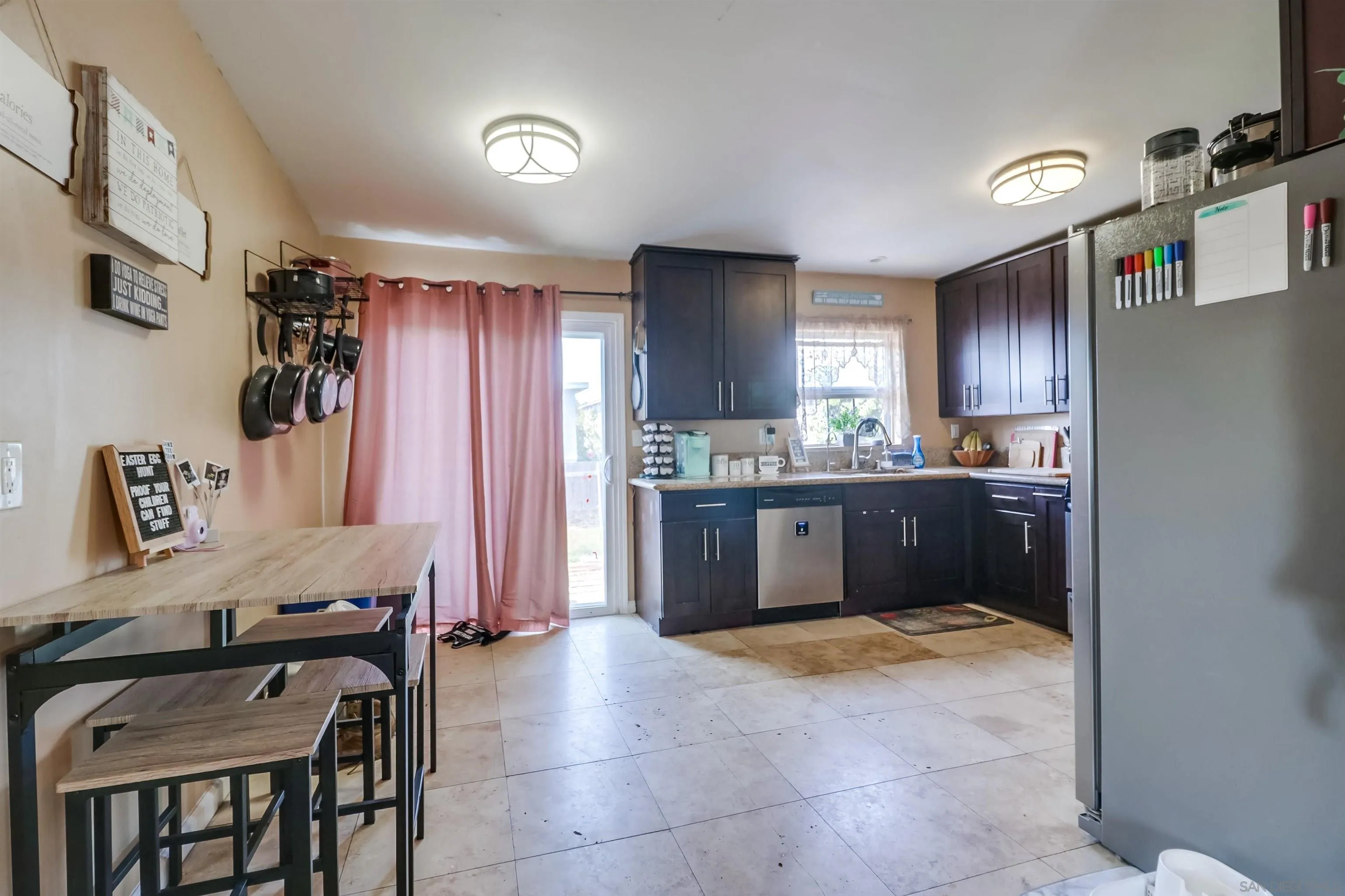 9833 St George Street Spring Valley, CA 91977 - Photo 6 of 19 a kitchen with a refrigerator a sink and a stove