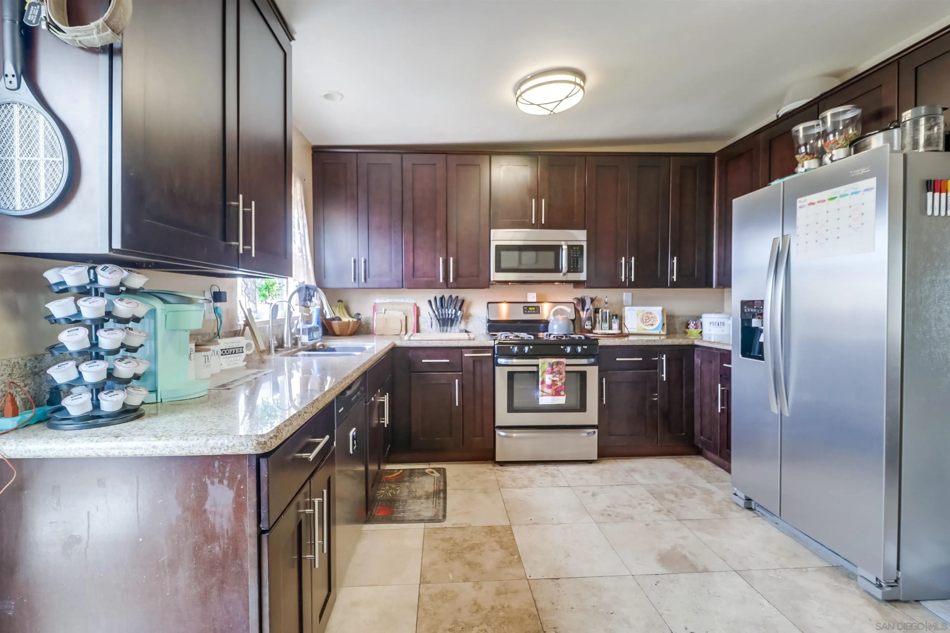 9833 St George Street Spring Valley, CA 91977 - Photo 8 of 19 a kitchen with stainless steel appliances granite countertop a refrigerator a stove and a sink