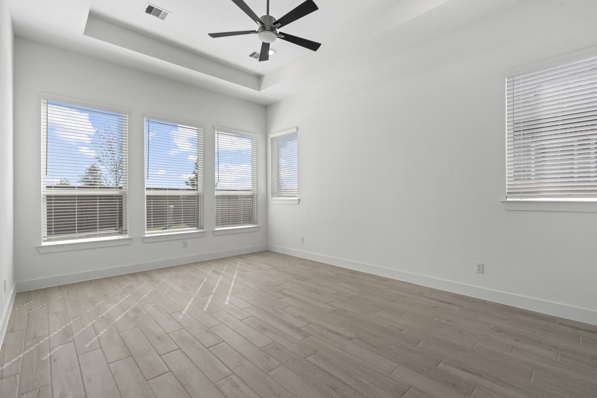 9103 Basilica Lane Manvel, TX 77578 - Photo 12 of 50 a view of an empty room with a window and wooden floor