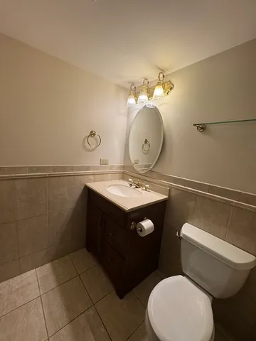 a bathroom with a sink mirror vanity and toilet