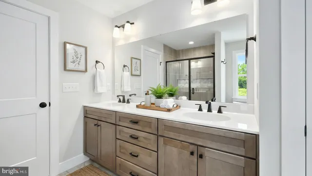 a bathroom with double sink and a mirror
