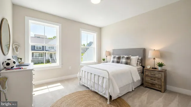 a bedroom with a bed and a dresser next to a window