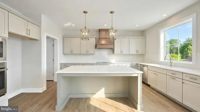 a kitchen with a stove a refrigerator and a sink