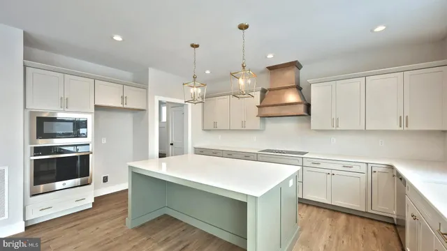 a kitchen with stainless steel appliances granite countertop a sink a stove and a refrigerator