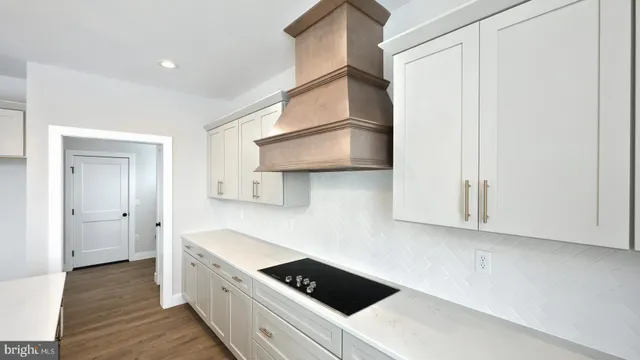 a kitchen with stainless steel appliances a sink a stove and cabinets