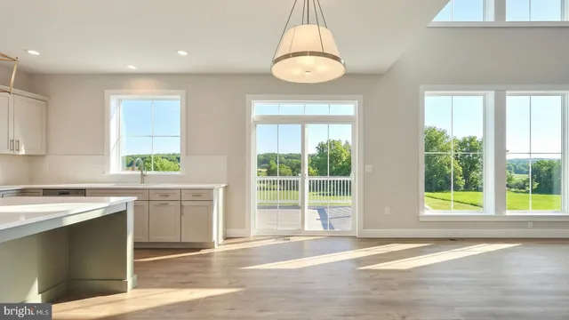 a large white kitchen with a large window