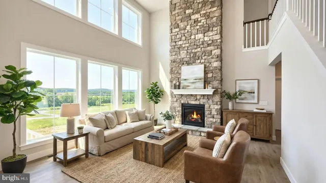 a living room with furniture a fireplace and a potted plant