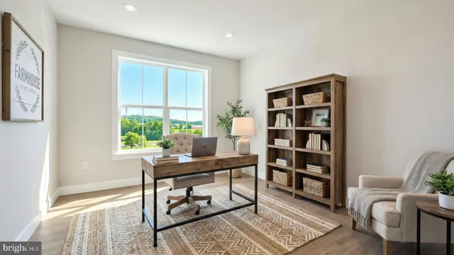 a view of a workspace with furniture and a window