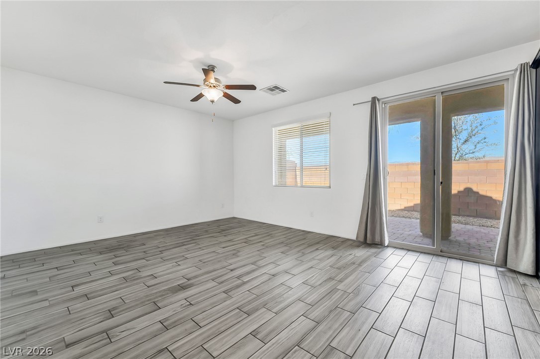 6245 Andover Wood Road Las Vegas, NV 89113 - Photo 14 of 37 Natural light fills this room with durable wood-look tile flooring.