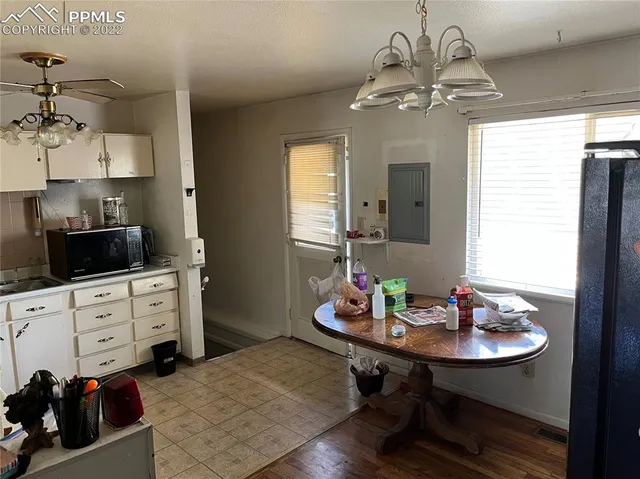 a kitchen with granite countertop white cabinets white stainless steel appliances and sink