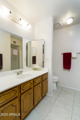 a spacious bathroom with a sink shower and a mirror
