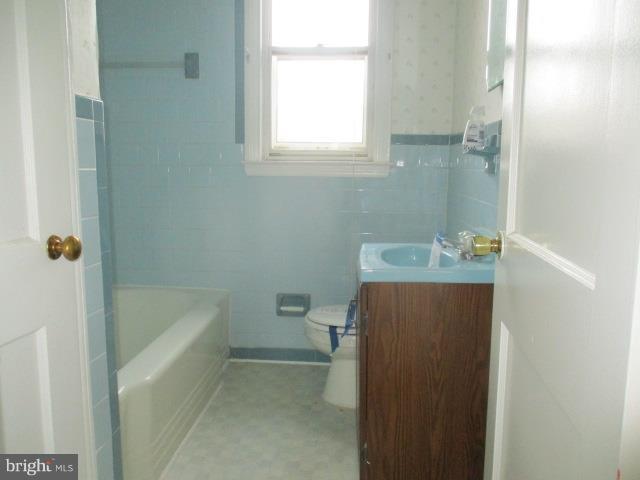 122 Hampshire Road Baltimore, MD 21221 - Photo 14 of 22 a bathroom with a sink a toilet and shower