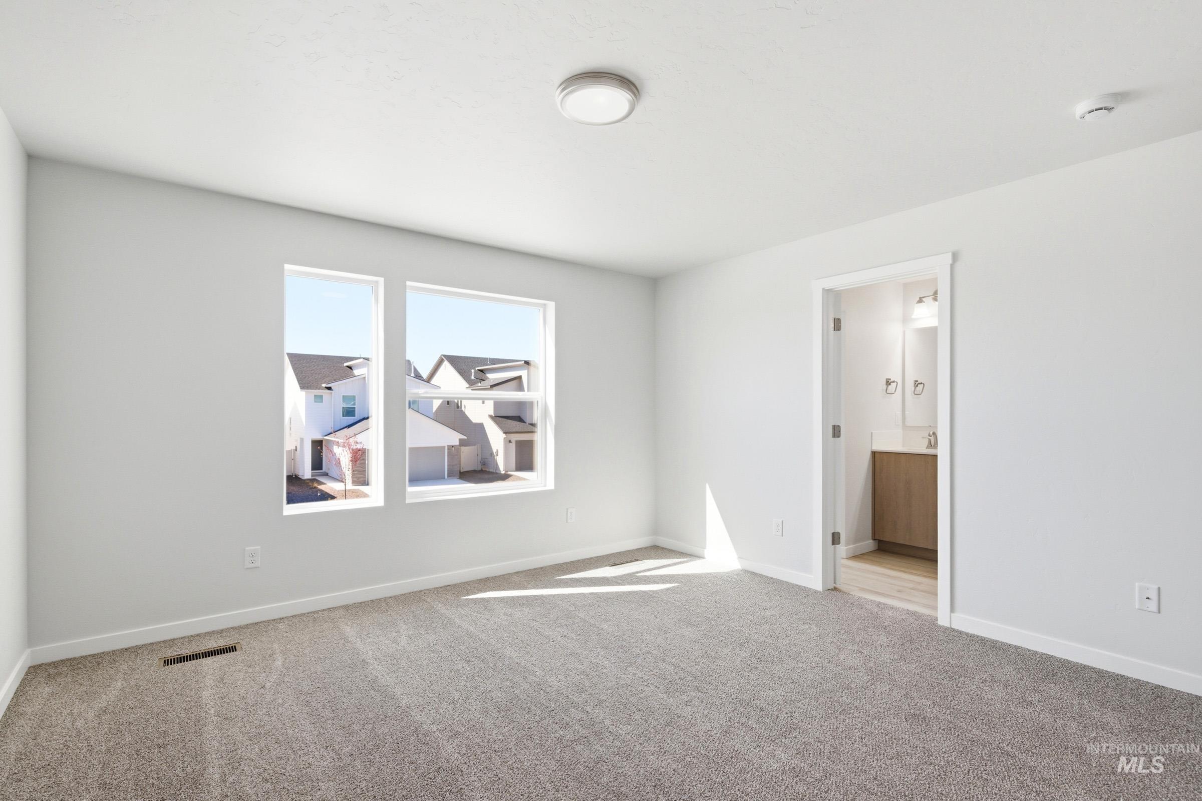 10800 Rutland Street Caldwell, ID 83605 - Photo 20 of 21 Carpeted room with multiple windows, recessed lighting, and white baseboards