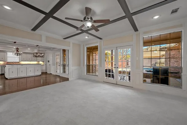 a living room with furniture ceiling fan and a large window