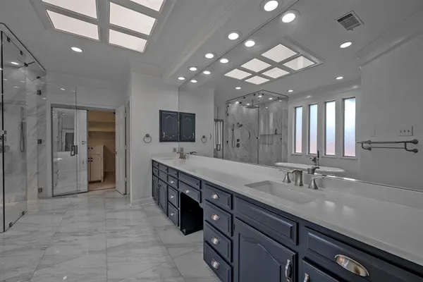 a bathroom with a sink double vanity and a large mirror