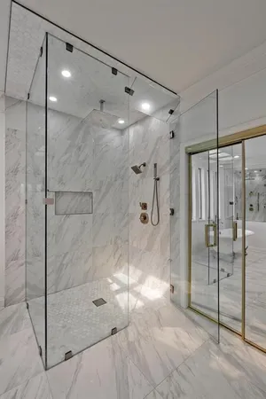 a bathroom with a glass shower door