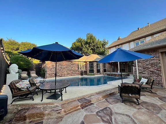 a patio with a patio table and chairs