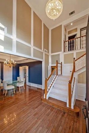 a view of a hallway with wooden floor and furniture