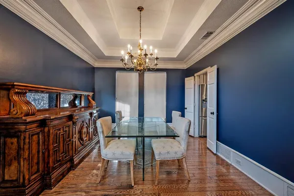 a view of a dining room with furniture and a chandelier