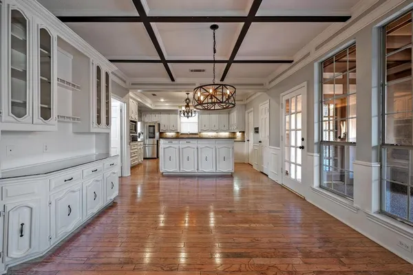 a large kitchen with stainless steel appliances granite countertop a stove and cabinets