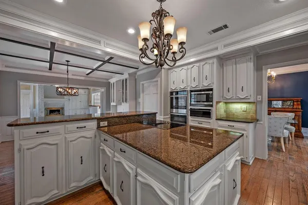 a kitchen with stainless steel appliances granite countertop a sink refrigerator and cabinets