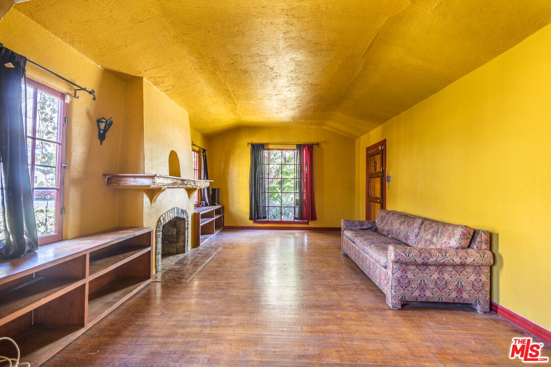 2371 Midvale Avenue Los Angeles, CA 90064 - Photo 6 of 33 a living room with furniture a fireplace and a flat screen tv
