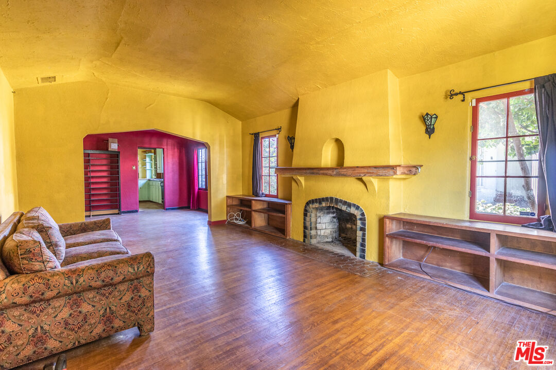 2371 Midvale Avenue Los Angeles, CA 90064 - Photo 7 of 33 a living room with furniture a fireplace and a flat screen tv
