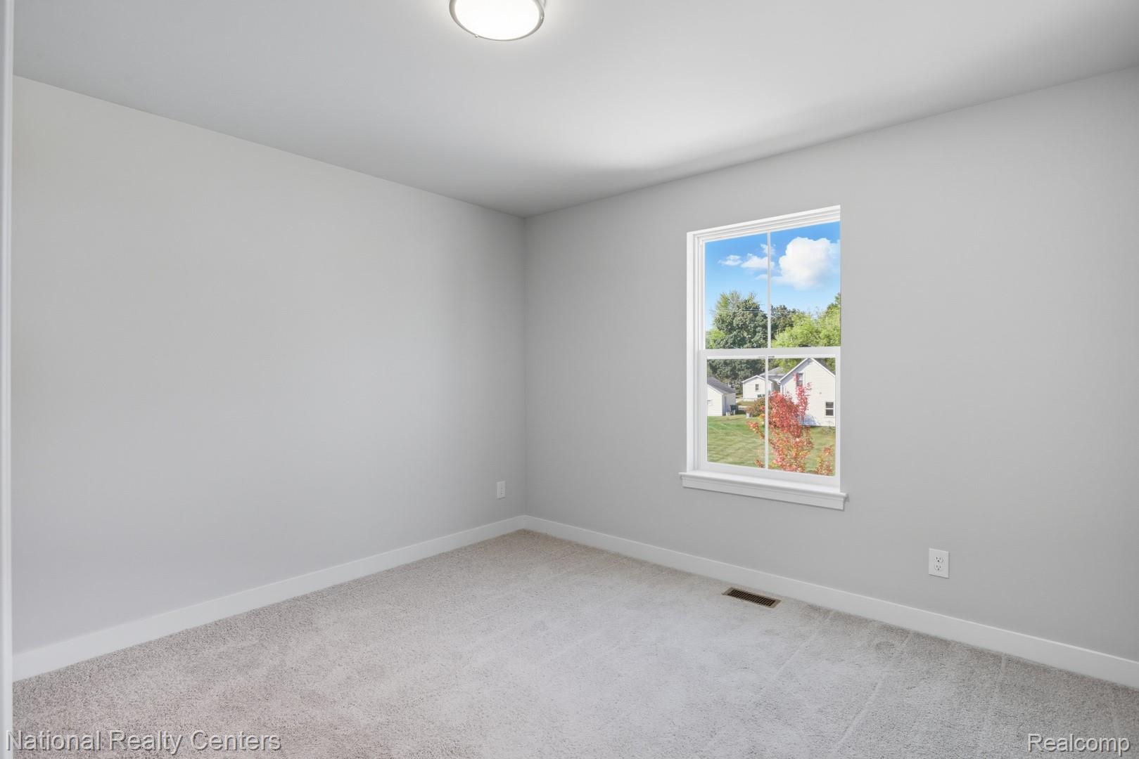 25018 Reeck Road Trenton, MI 48183 - Photo 21 of 32 Neutral wall finish, carpeted flooring, and a double-hung window with white trim
