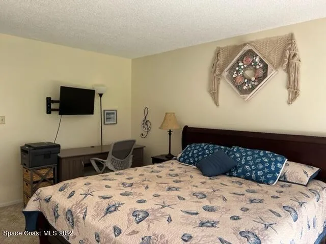 a bedroom with a bed and a table in it