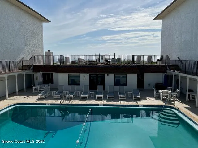 a view of swimming pool with outdoor seating