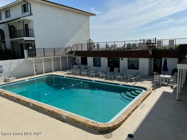 a view of a swimming pool with a chairs