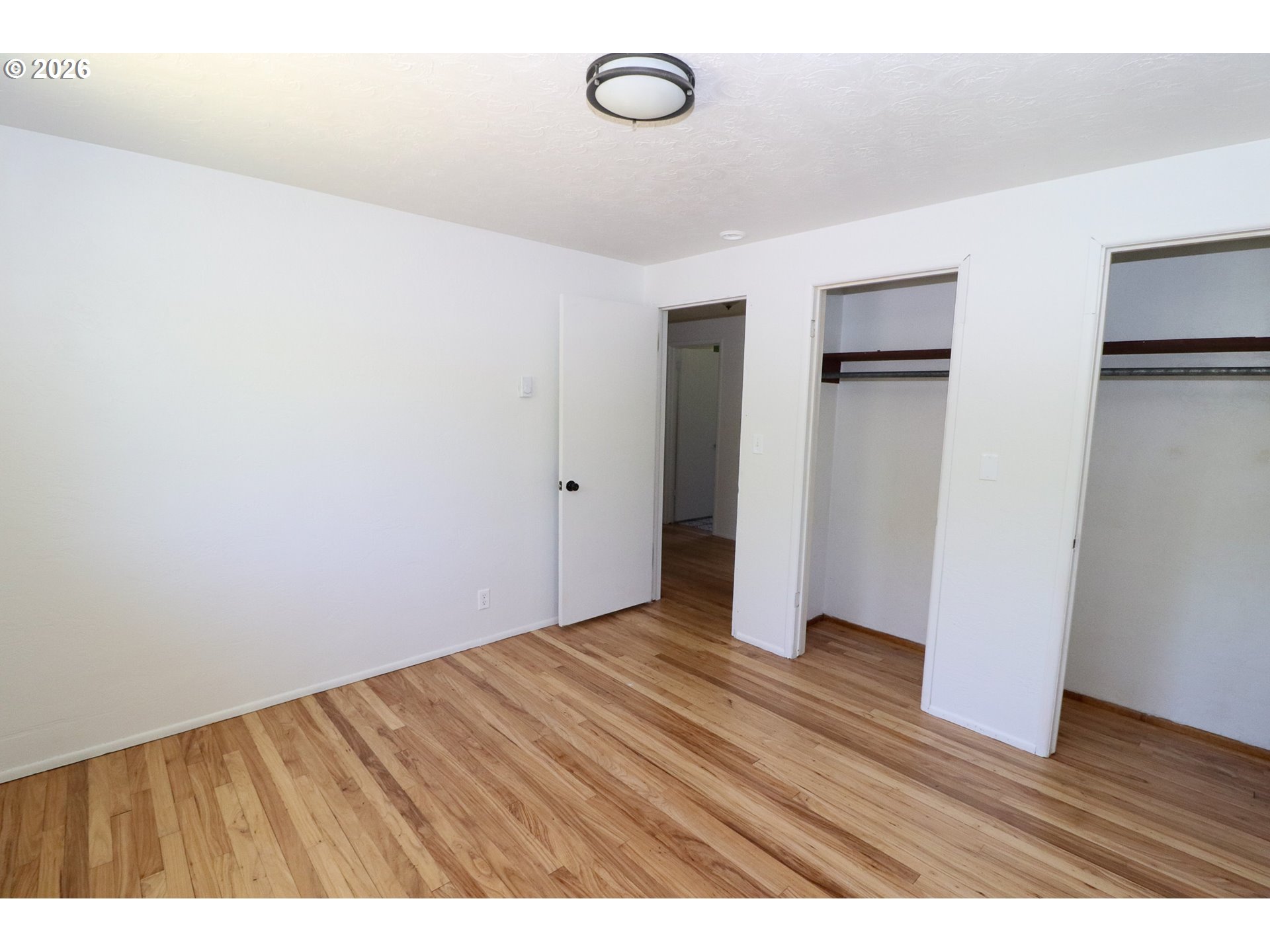 7077 Main Street Springfield, OR 97478 - Photo 20 of 34 a view of an empty room with wooden floor