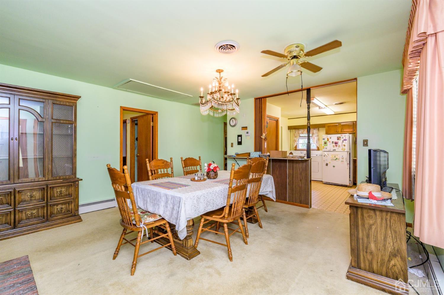 370 East Millstream Road Cream Ridge, NJ 08514 - Photo 12 of 54 a view of a dining room with furniture and a chandelier