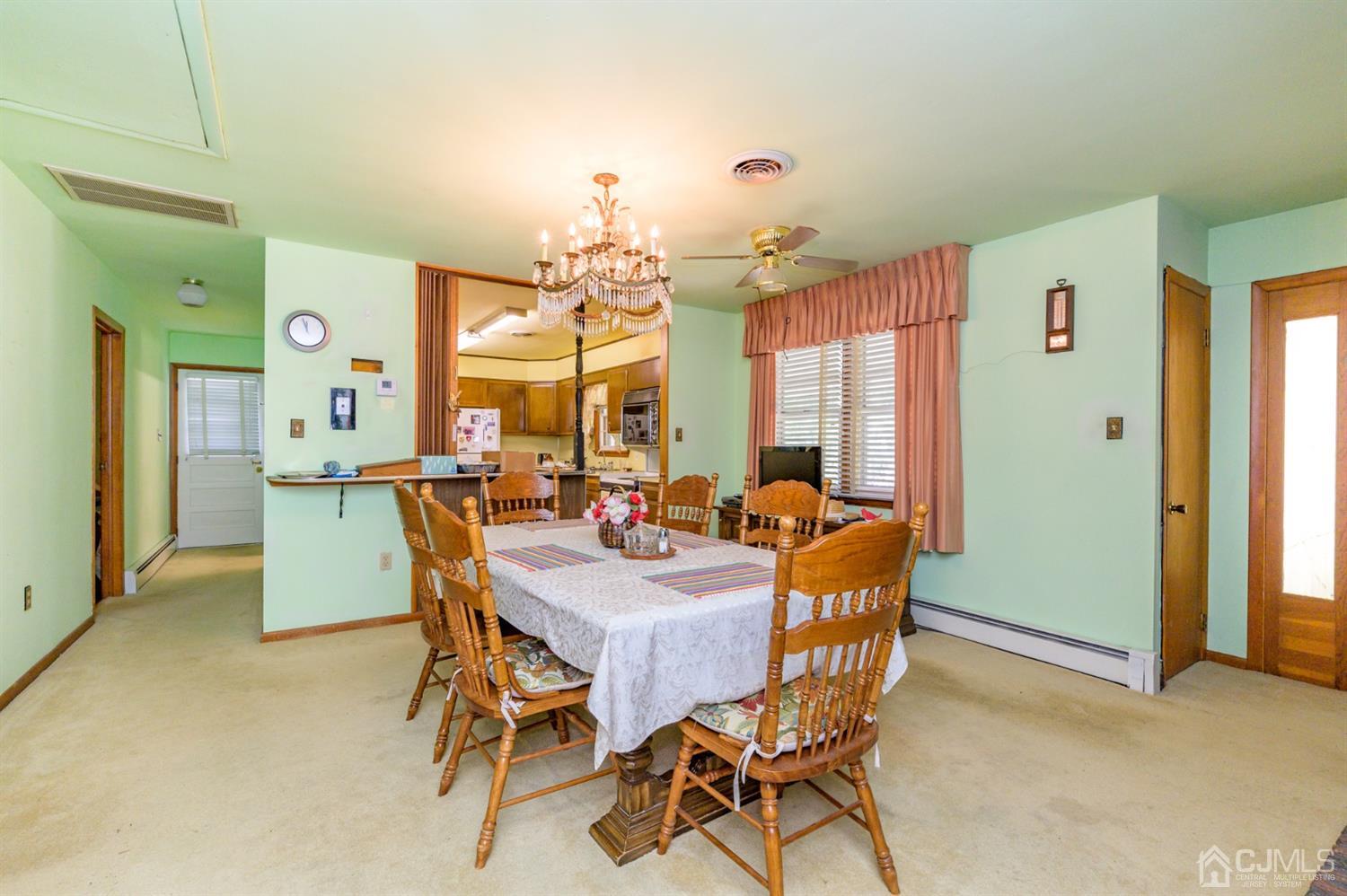 370 East Millstream Road Cream Ridge, NJ 08514 - Photo 13 of 54 a dining room with furniture and a chandelier