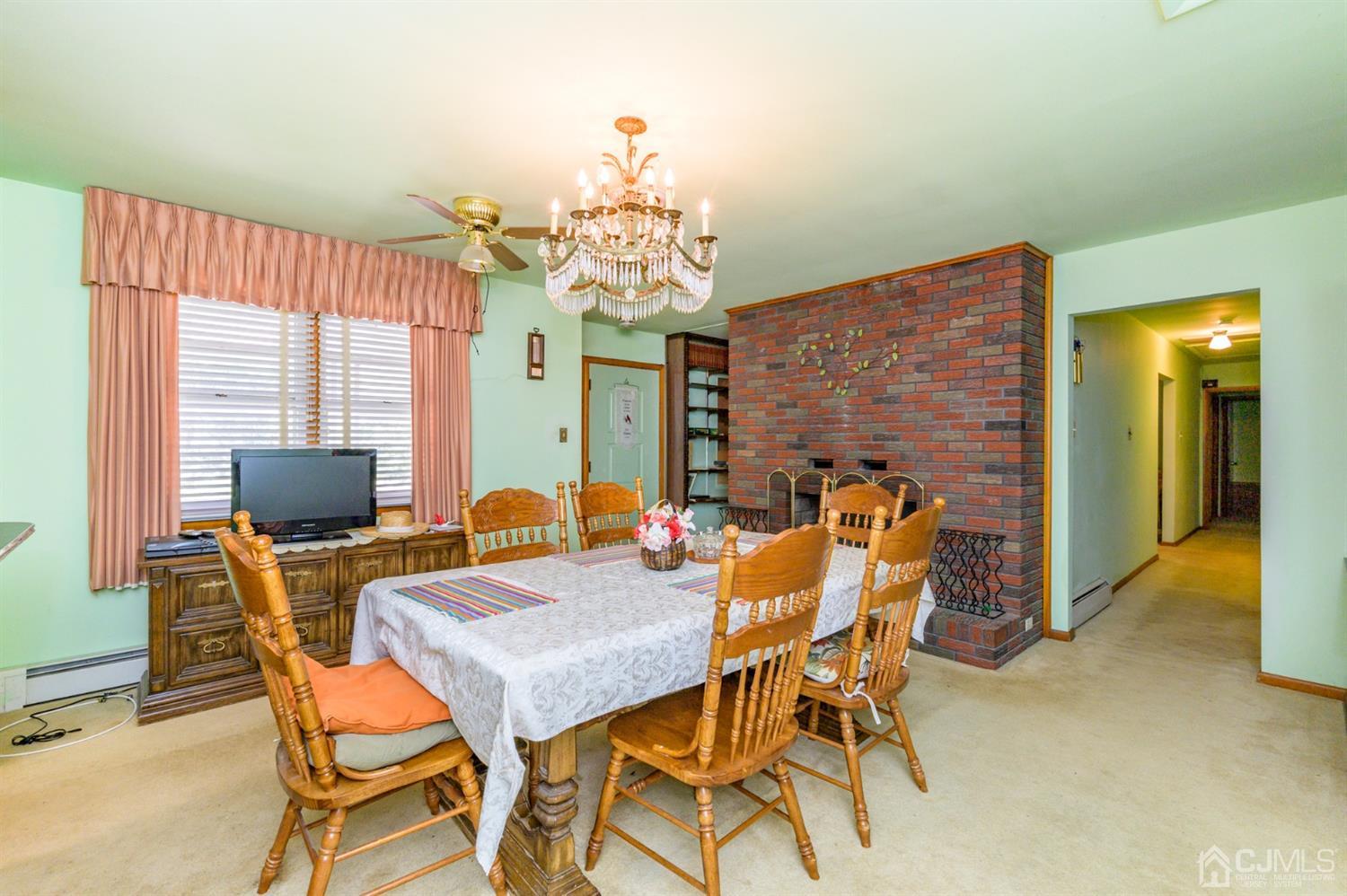 370 East Millstream Road Cream Ridge, NJ 08514 - Photo 14 of 54 a view of a dining room with furniture and a chandelier