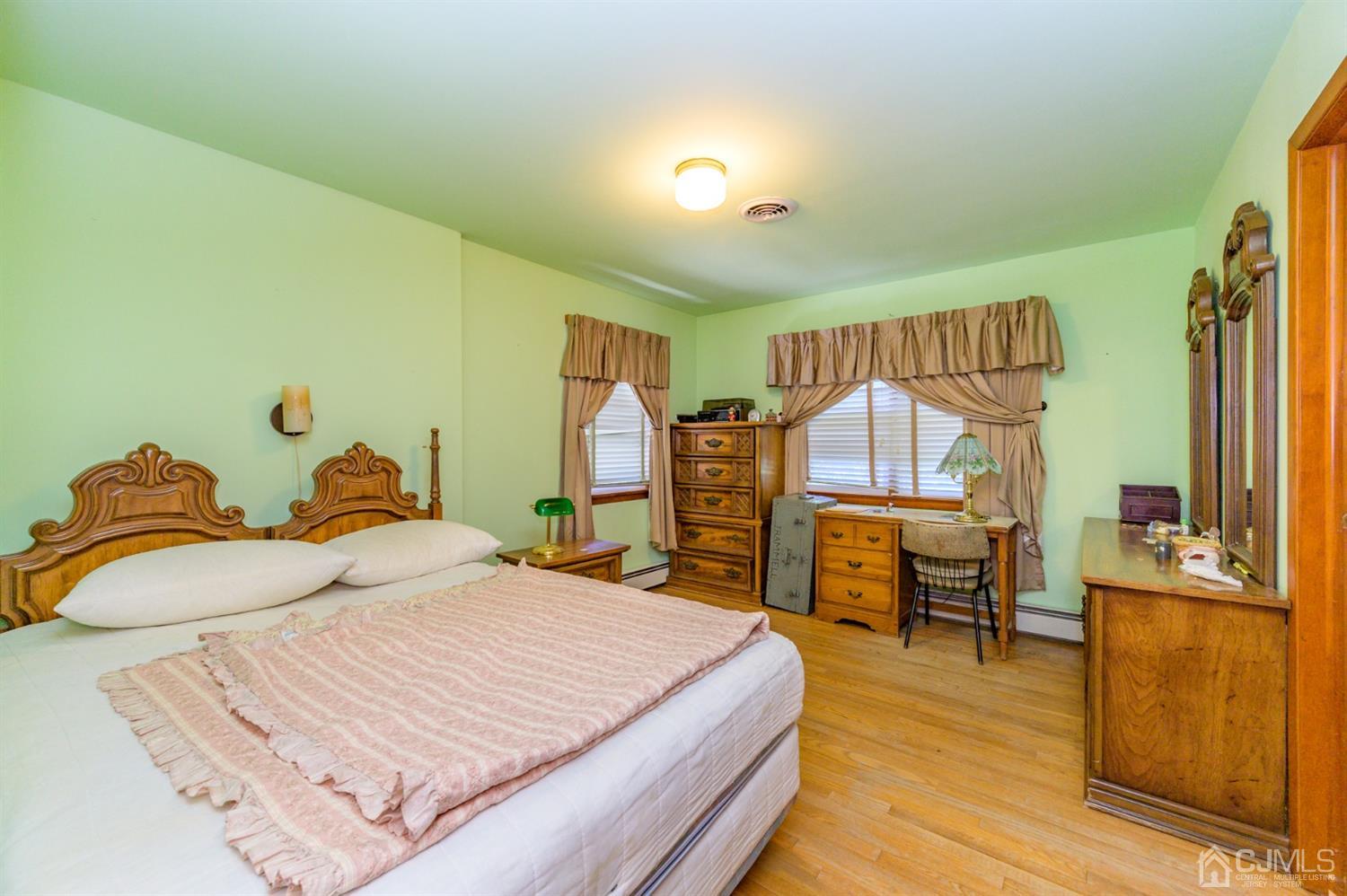370 East Millstream Road Cream Ridge, NJ 08514 - Photo 26 of 54 a bedroom with a bed and wooden floor