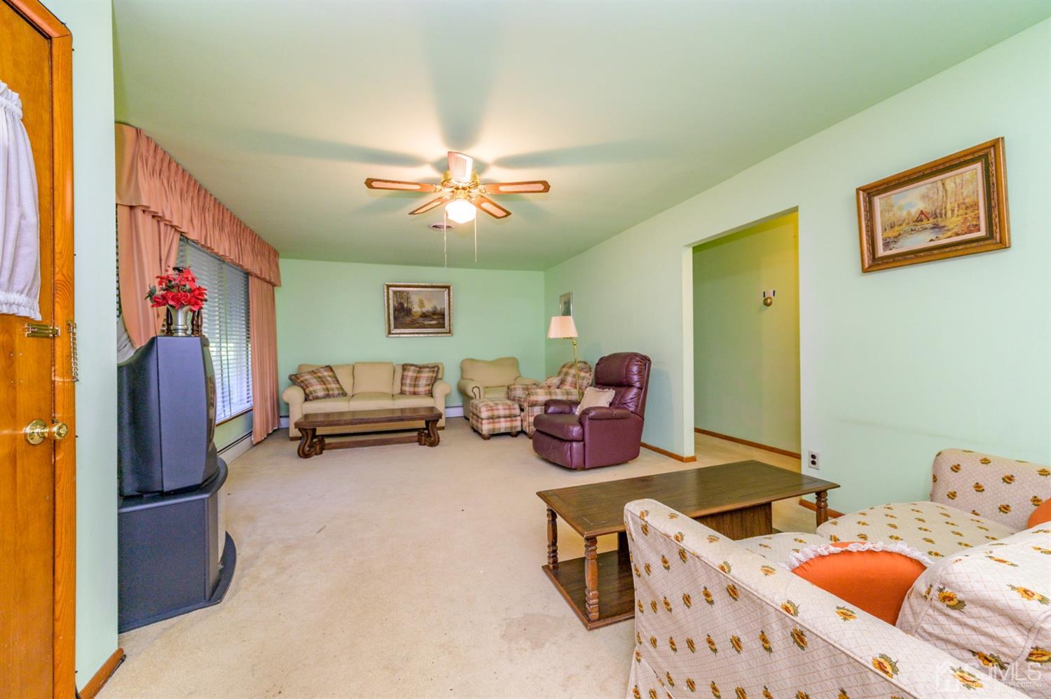 370 East Millstream Road Cream Ridge, NJ 08514 - Photo 7 of 54 a view of a livingroom with furniture and a flat screen tv
