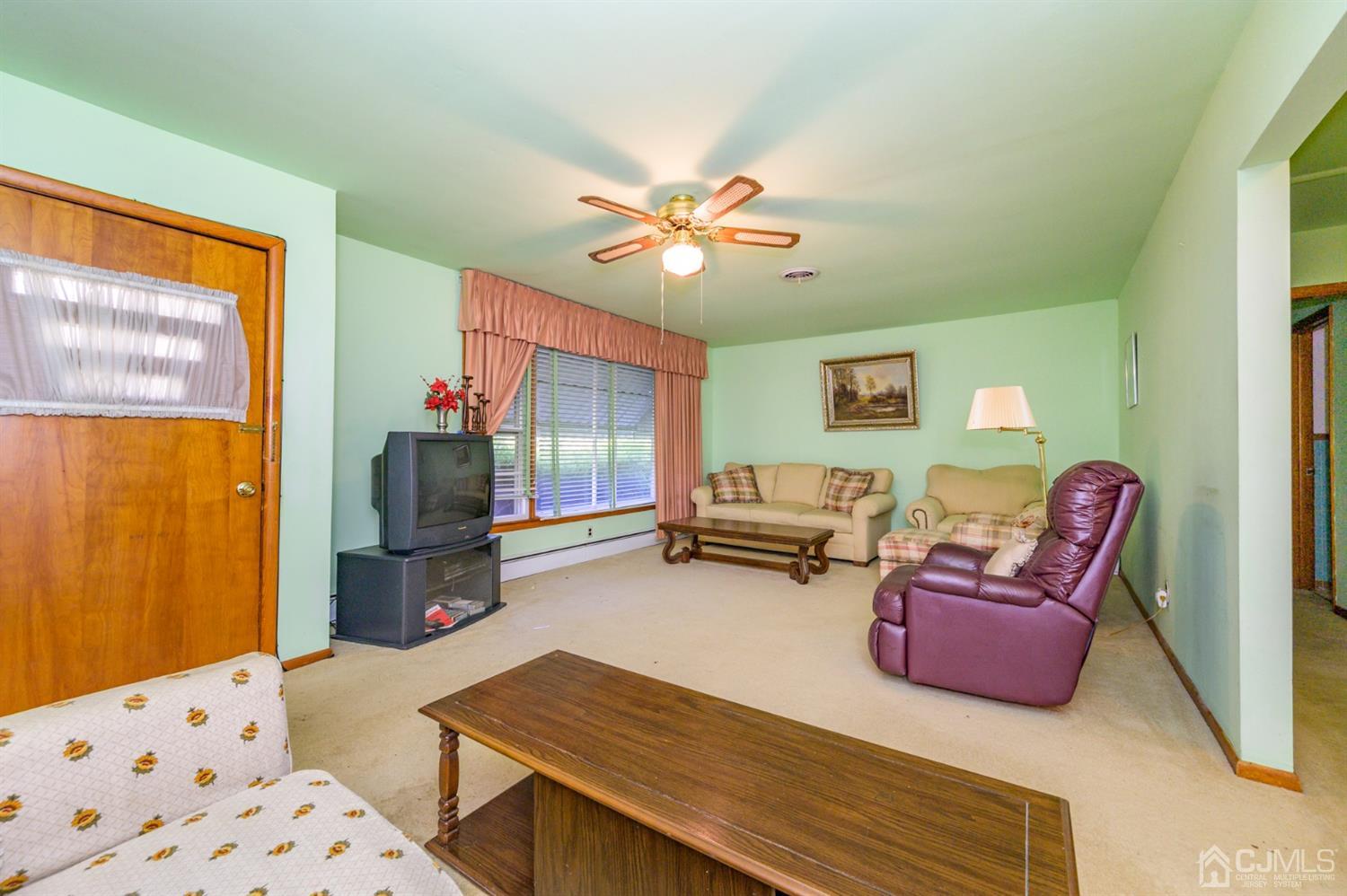 370 East Millstream Road Cream Ridge, NJ 08514 - Photo 8 of 54 a living room with furniture and a flat screen tv