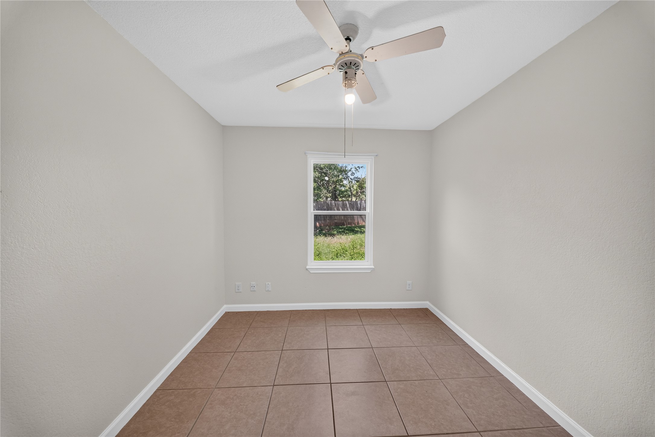 339 Fantail Loop, Unit B Austin, TX 78734 - Photo 21 of 21 an empty room with a window and a ceiling fan