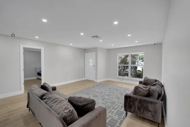 a large kitchen with stainless steel appliances granite countertop a lot of counter space and a sink