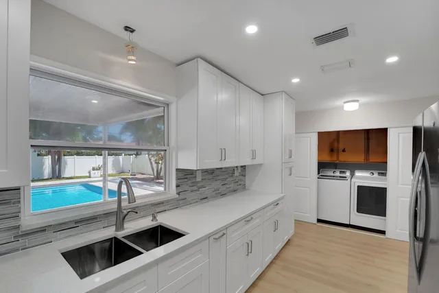 a kitchen with cabinets appliances and a counter space