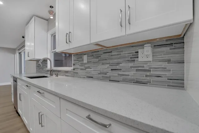 a kitchen with granite countertop cabinets stainless steel appliances and a counter space