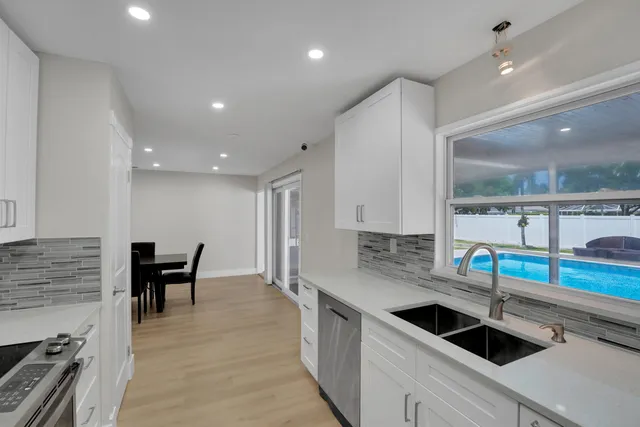 a large kitchen with stainless steel appliances kitchen island granite countertop a large counter top stainless steel appliances and cabinets