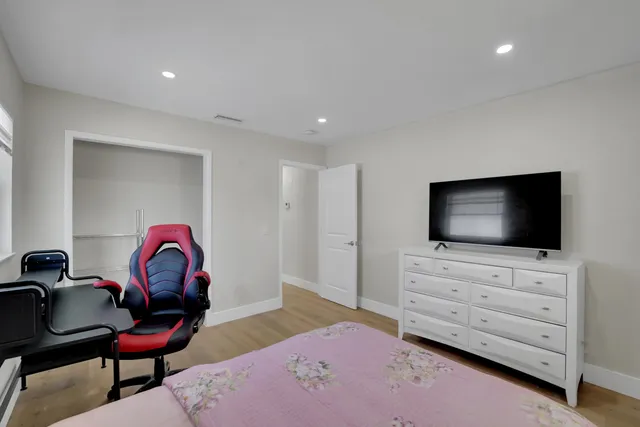 a view of a patio with a table and chairs under an umbrella