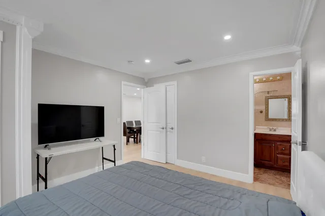 a view of a backyard with lawn chairs potted plants and wooden fence